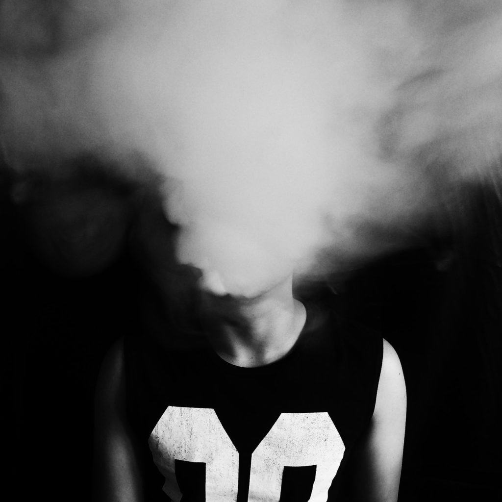 blowing a cloud of smoke